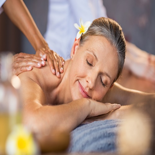 Woman receiving massage at spa